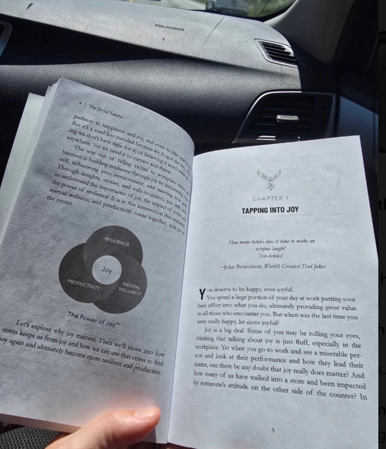 An open copy of The Joyful Leader by Nicole Van Valen showing the Power of Joy diagram and Chapter 1, Tapping Into Joy