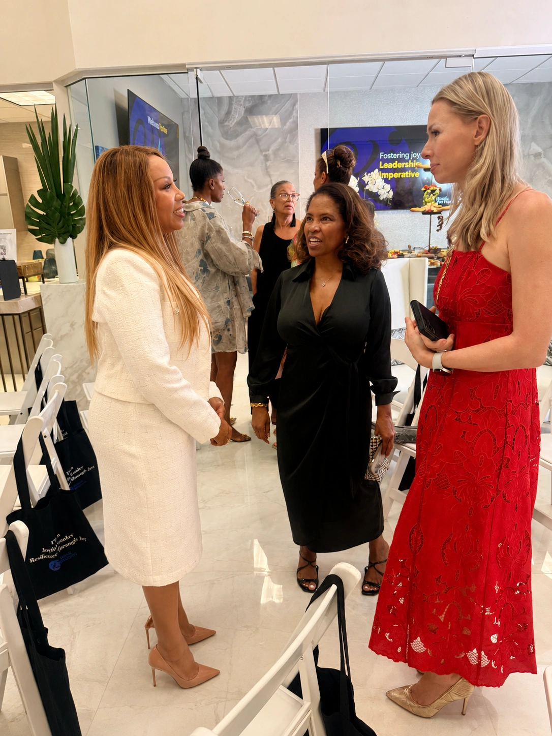 Nicole Van Valen smiling in conversation at a professional event, warm natural light